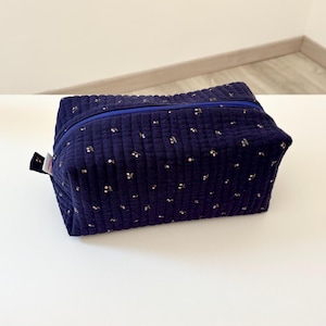 Extra large toiletry bag in navy blue quilted cotton fabric with small pink cherry patterns.