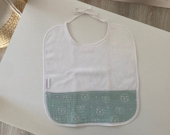 White and soft green baby bib with little teddy bear patterns