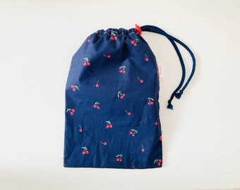 Waterproof bag for wet swimsuits in navy blue coated cotton fabric with small cherry patterns