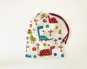 Sac imperméable pour maillot de bain mouillé en tissu coton enduit blanc cassé motifs dinosaures colorés