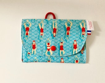 Waterproof soap pouch in blue coated fabric with little swimmers pattern and white interior.