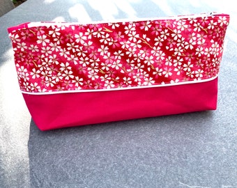 Large pink toiletry bag and pink Japanese fabric with white and gold cherry blossom patterns