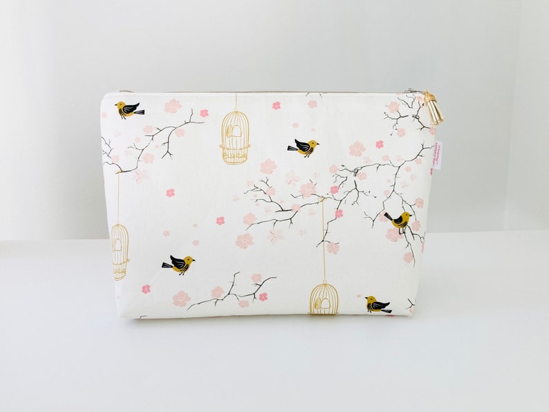 Large toiletry bag in creamy white cotton fabric with Japanese patterns of small cherry blossoms, cages and birds. image 1