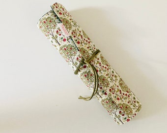 Makeup or paint brush case, in fabric with patterns of small apple trees, interior in matching dark green cotton fabric.