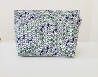 Large toiletry bag in white Japanese fabric with wave patterns and green and navy blue koi carps.