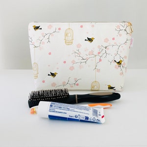 Large toiletry bag in creamy white cotton fabric with Japanese patterns of small cherry blossoms, cages and birds. image 2