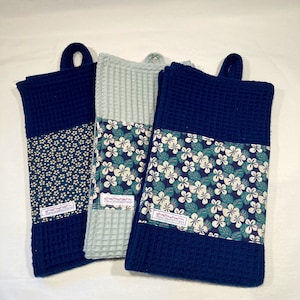Tea towel in pale green or navy blue oeko tex honeycomb fabric and decorative band in floral pattern cotton fabric.