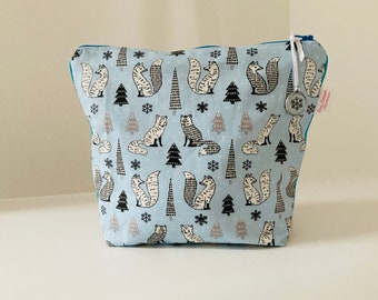 Toiletry bag in sky blue coated canvas with little polar fox patterns