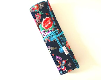 Makeup or paint brush case in navy blue Japanese fabric with flowers and butterflies and matching turquoise blue cotton fabric.