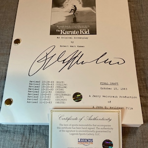 May include: A signed screenplay for "The Karate Kid" with a certificate of authenticity. The script is titled "An Original Screenplay" by Robert Mark Kamen. The certificate is from Legends Sports Gallery, LLC.