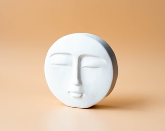 Minimalist decorative sculpture moon face