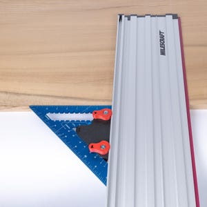 May include: A blue and black woodworking square with red knobs is attached to a silver and red track system labelled "MILESCRAFT".