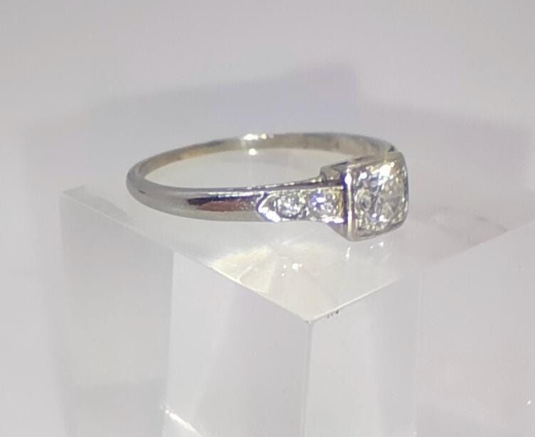 An Art Deco antique platinum and diamond solitaire engagement ring size N 1/2