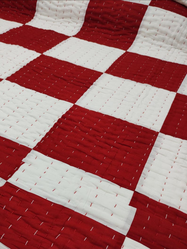 Red & white kantha quilt.