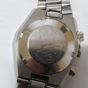 May include: Silver Seiko wristwatch with a stainless steel band. The back of the watch has the text "SEIKO WATER RESISTANT 781309 JAPAN A 6139-7030 STAINLESS STEEL".