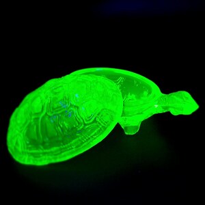 May include: A bright green glass turtle trinket box with a lid. The turtle is detailed with a shell pattern and has a smooth, glossy finish.