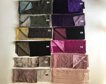 May include: A collection of fabric swatches in various colors, including teal, olive green, gold, black, purple, and pink. Each swatch is folded to reveal a contrasting fabric on the reverse side. The swatches are numbered 01 through 12.