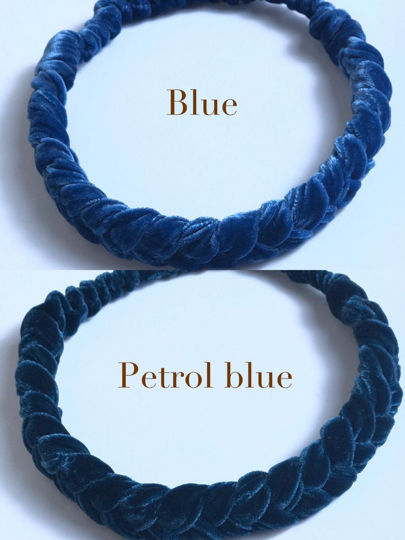 May include: Two velvet headbands, one blue and one petrol blue. The headbands are braided and are shown on a white background.