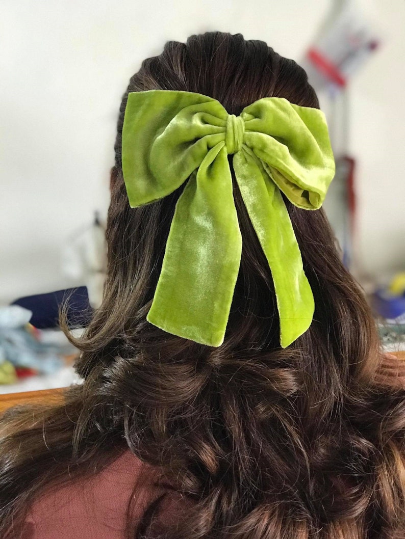 May include: A large lime green velvet bow hair clip.