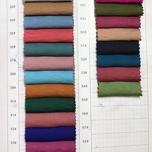 May include: A fabric swatch card with 15 rows of fabric samples. Each row is numbered with a number from 31 to 60. The fabric samples are in a variety of colors and textures.