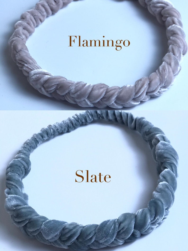 May include: Two braided velvet headbands, one in a light pink color labeled "Flamingo" and the other in a light blue color labeled "Slate".