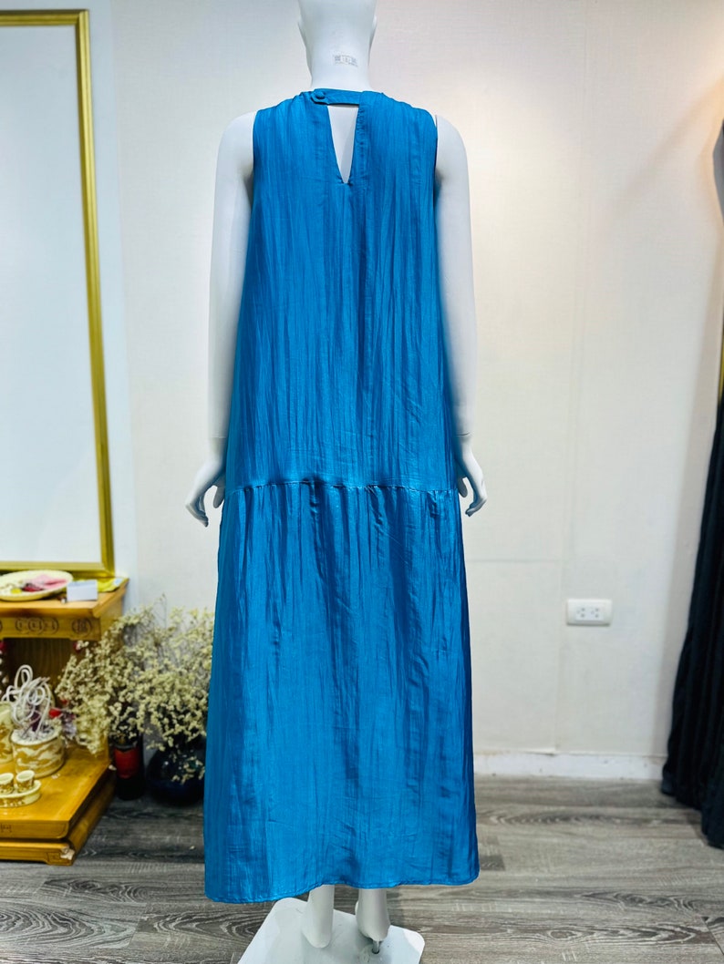May include: A sleeveless maxi dress in a vibrant blue color. The dress has a V-neckline and a flowy, relaxed fit.