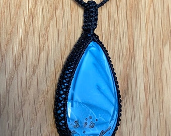 Blue owyhee opal macrame pendant on black waxed cord