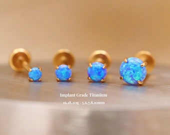 May include: Three gold titanium opal earrings with blue opals. The earrings are 5, 6, 7, 8, and 10 mm in size. Implant Grade Titanium 16, 18, 20g.