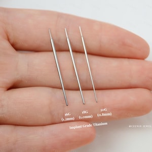 May include: Three straight, silver-colored implant grade titanium piercing taper pins. The pins are labeled with gauges and metric sizes: 16G (1.2mm), 18G (1.0mm), and 20G (0.8mm). The pins are thin, smooth, and have pointed tips.