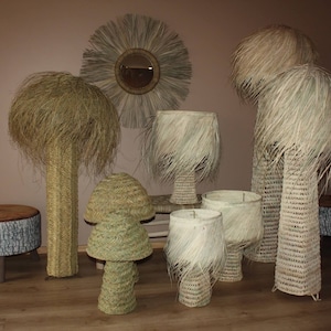 May include: A collection of woven lamps with natural grass shades. The lamps are in various sizes and styles, with some featuring a tall, cylindrical base and others with a shorter, mushroom-shaped base.