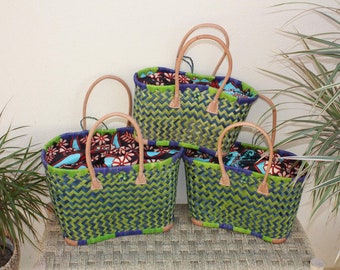 May include: Four woven green and blue market bags with brown leather handles and colorful fabric lining.