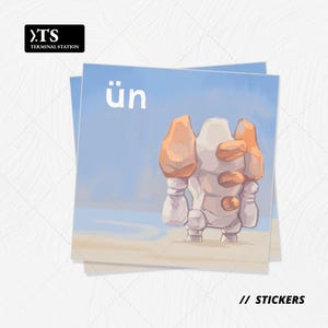 May include: Two stickers featuring a cartoon character with a white body and orange accents, standing in a desert scene. The word "ün" is printed in white on a light blue background. The Terminal Station logo is in the upper left corner. The text "// STICKERS" is at the bottom.