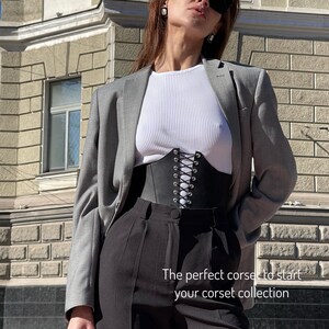 a woman in a business suit and sunglasses