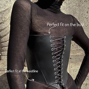 a woman wearing a black corset with laces