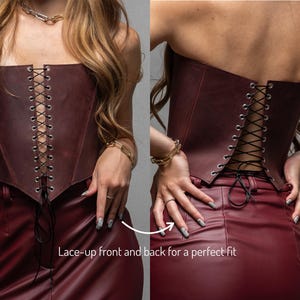 a woman wearing a leather corset with her hands on her hips