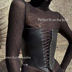 a woman wearing a black corset with laces