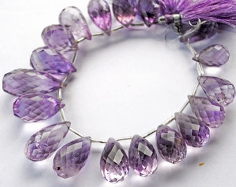 May include: A strand of faceted amethyst gemstone beads in a teardrop shape. The beads are strung on a silver wire and are approximately 18 inches long.