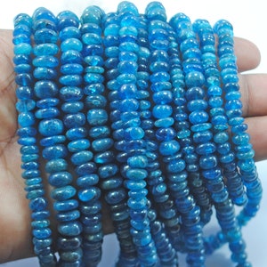 May include: Strands of blue gemstone beads in varying sizes. The beads are a vibrant, translucent blue, with a polished, rounded shape. The beads are strung together, creating a necklace or bracelet.