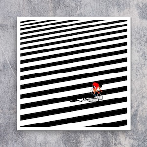 May include: A black and white striped background with a person riding a bicycle in the center. The person is wearing a red shirt and black shorts. The bicycle is black with white tires.