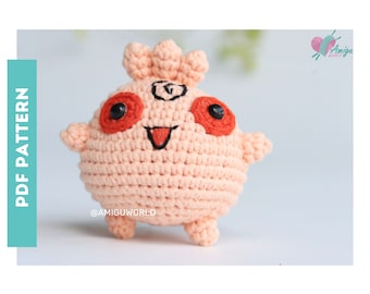 May include: A peach-colored, crocheted amigurumi figure with red eyes and a smiling mouth. The figure has small arms and legs, and a small tuft of hair on top. The text "PDF PATTERN" is on the left side of the image, and the Amigu World logo is in the upper right.