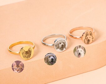 May include: Four personalized rings with engraved images of pets. The rings are in gold, silver, and rose gold. The images include a cat, a dog, and two different dogs.
