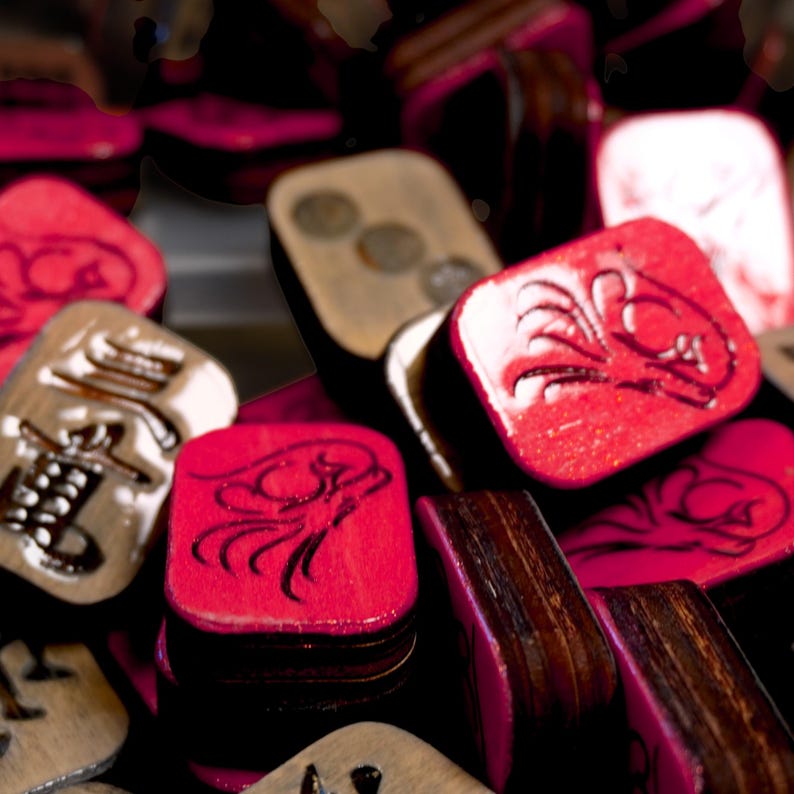 Close-up of handmade wooden Riichi Mahjong tiles with red glitter dragon design, ready to ship