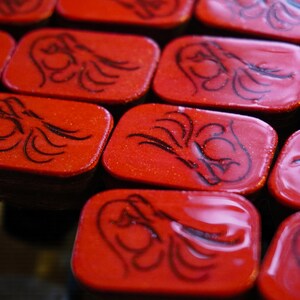 Close-up of handmade wooden Riichi Mahjong tiles with red glitter dragon design, ready to ship