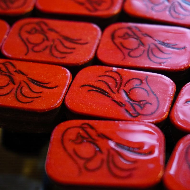 Close-up of handmade wooden Riichi Mahjong tiles with red glitter dragon design, ready to ship