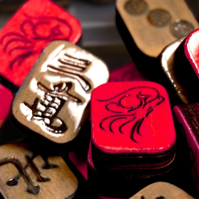 Close-up of handmade wooden Riichi Mahjong tiles with red glitter dragon design, ready to ship