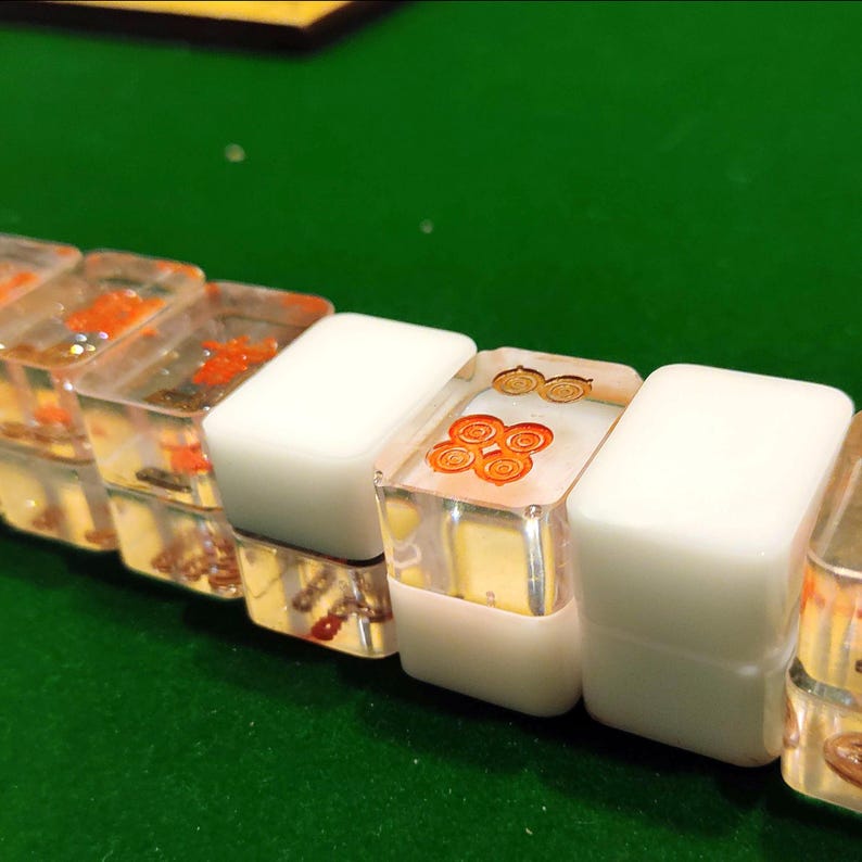 Handmade Washizu-style mini travel Riichi Mahjong tiles, three transparent and one opaque per type, crafted from resin with clear and solid pieces for authentic gameplay.