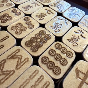 Handcrafted American Mahjong tiles featuring an adorable lazy panda on an aqua background with pink polka dots, engraved and hand-painted wooden tiles made from layered basswood with matching suit engravings on the front, ready to ship within one business day.
