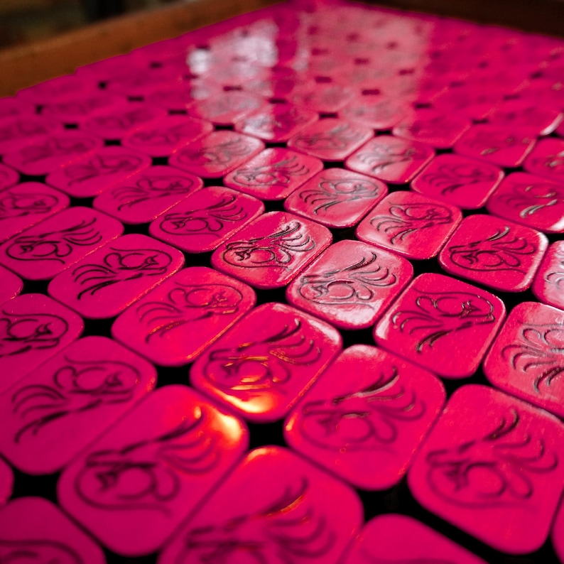 Close-up of handmade wooden Riichi Mahjong tiles with red glitter dragon design, ready to ship