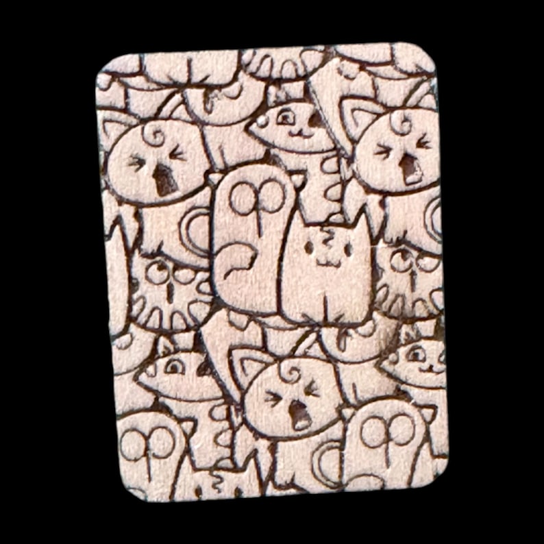 Handmade wooden Mahjong tile featuring a laser-engraved cat doodle design with playful cartoon cats and quirky expressions. Perfect for Riichi or American Mahjong tile sets, this unique engraved tile back adds fun, charm, and personality to your game. Custom options include engraved only, hand-painted, or spot color accents on durable basswood with a glossy urethane finish.