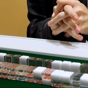 Handmade Washizu-style mini travel Riichi Mahjong tiles, three transparent and one opaque per type, crafted from resin with clear and solid pieces for authentic gameplay.